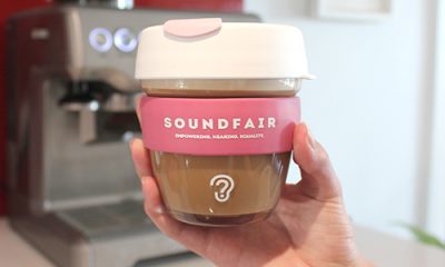 A Soundfair keepcup, full of coffee