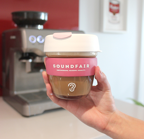 A Soundfair keepcup, full of coffee